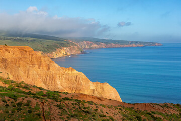 Fototapeta na wymiar the beautiful blue waters and yellow cliff faces on the fleurieu peninsula at sellicks beach south australia on july 14 2020