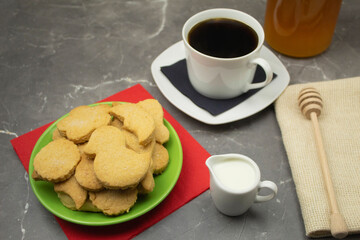 Cookies in a plate and coffee with milk