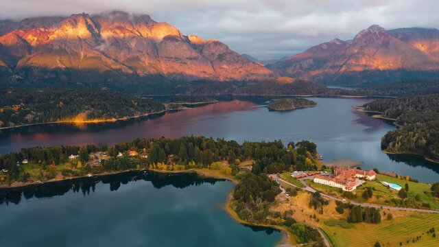 Dramatic Patagonia sunset, hotel resort in mountain landscape, aerial view