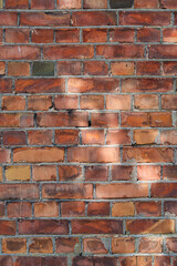 Brick wall background or texture with day light spots.