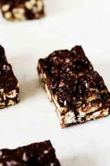 Raw Chocolate Hazelnut cake slices on white marble background. Selective focus