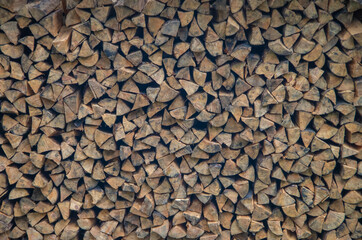 Wooden natural background firewood stacked in a neat woodpile