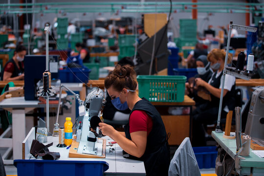 Shoe making process in footwear factory.