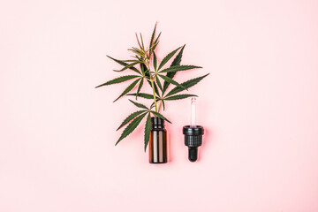 Sprig of cannabis in a bottle for cosmetics. The concept of using hemp for medical and cosmetic...
