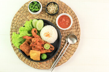 Ayam Taliwang is Lombok's Special Food, Made from Young Smoked Chicken, Spiced and Grill with Chilli Sauce. Served with Plecing Kangkung (Water Spinach) and Rice