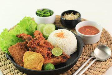 Ayam Taliwang is Lombok's Special Food, Made from Young Smoked Chicken, Spiced and Grill with Chilli Sauce. Served with Plecing Kangkung (Water Spinach) and Rice