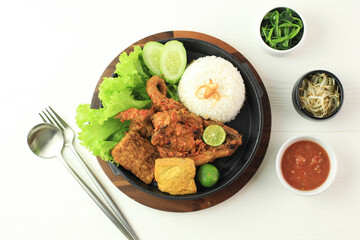 Ayam Taliwang is Lombok's Special Food, Made from Young Smoked Chicken, Spiced and Grill with Chilli Sauce. Served with Plecing Kangkung (Water Spinach) and Rice