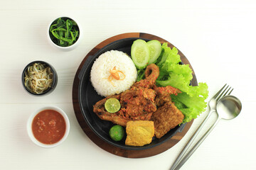 Ayam Taliwang is Lombok's Special Food, Made from Young Smoked Chicken, Spiced and Grill with Chilli Sauce. Served with Plecing Kangkung (Water Spinach) and Rice
