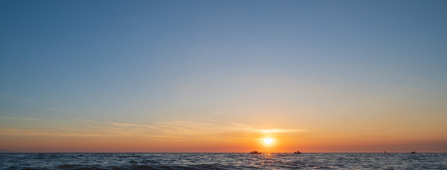 Naklejka na ściany i meble sunset over the sea background