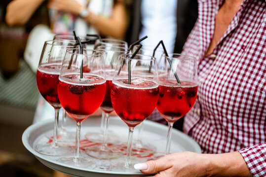 Glasses With Alcoholic Fruit Cocktail With Berries On A Tray At The Waitress