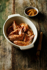 Raw marinated chicken with spices, selective focus.