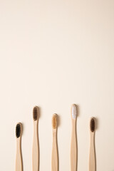 Eco bamboo toothbrushes arranged on cream background