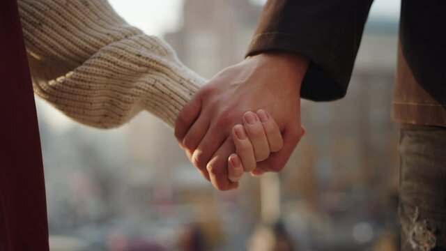Closeup couple meeting hands outdoors. Love couple holding hands