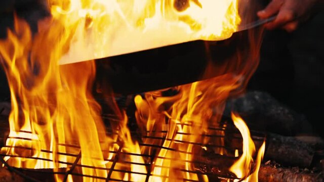 Roasting chicken on a campfire in slowmotion