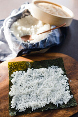 plant-based food, vegan sushi with seaweed and sticky rice getting prepared