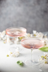 Homemade pink vodka cosmopolitan cocktail drink in crystal glasses