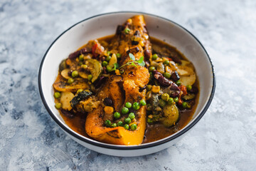 plant-based food, vegan butternut squash roast with beans and mixed mediterrnean vegetables in spicy broth