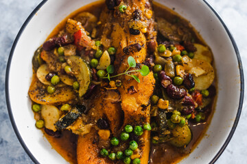plant-based food, vegan butternut squash roast with beans and mixed mediterrnean vegetables in spicy broth