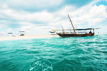 Boat in ocean near sand bank in Zanzibar