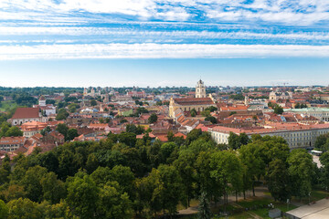 View of Vilnius city from the Gedimin’s tower. Observation deck at a height. Roofs of houses, trees, streets, sky of the old city. Lithuania.