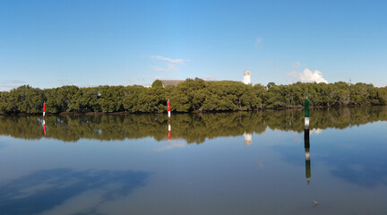 beautiful early morning panoramic view of river with reflections of clear blue sky and trees on water, Parramatta river, Rydalmere, New South Wales, Australia