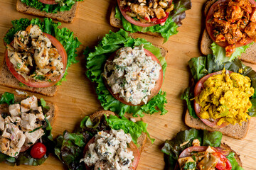 Sandwiches. Tuna Salad. Chicken Salad. Served on slices of white, rye, and whole grain bread with lettuce and tomato. Traditional American lunch or snack favorite. 