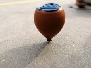 wooden spinning top while spinning on the