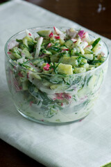 Cucumber salad. Traditional Greek salad with cucumbers with cherry tomatoes and tossed with Greek yogurt fresh dill olive oil, lemon juice and seasoned with salt and pepper.