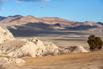 Sunny day among rock fields trees and desert looking out from Moonrocks Nevada