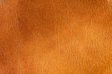 Genuine leather texture burnt orange color. Leather surface. Close up. Copy space.