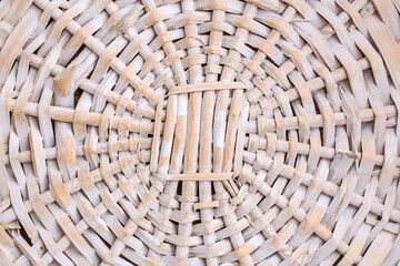 The surface of a round wicker basket. Wicker texture.  Close up. Top view. Natural background with copy space.