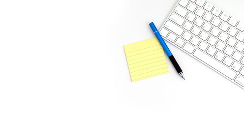 VOIP headset, pen and paper note on laptop computer keyboard. Communication support for callcenter and customer service Helpdesk.