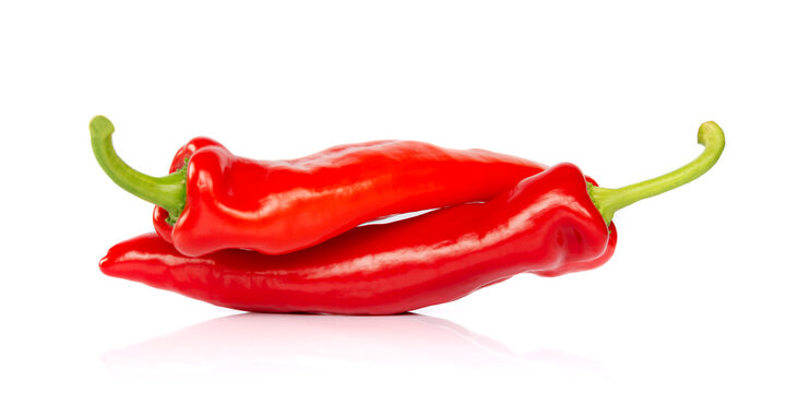Two red hot chili pepper isolated on white background, looking like people having sex in 69 posture