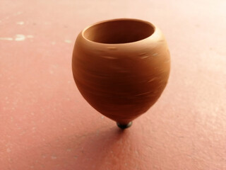 wooden spinning top while spinning on the ground