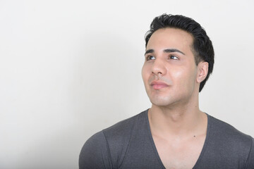 Portrait of young handsome man against white background