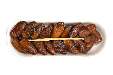 Dried dates in plastic packaging isolated on a white background. Top view. Ripe, neatly stacked.