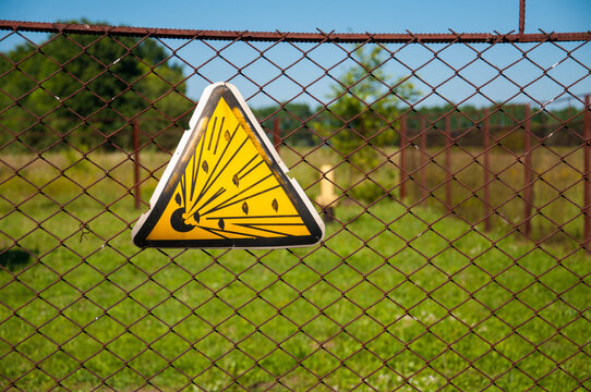 Explosion danger sign hanging on the fence around the gas installation