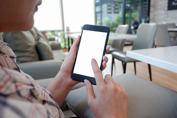 Cropped shot view of woman’s Hands hold the smartphone with blank copy space screen for your information content or text message on the gray granite at the modern place.