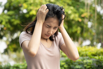 sick asian woman having fever or headache; concept of virus infection, coronavirus COVID-19 flu, vertigo, dizziness, depression, depressed woman, health care medical concept