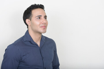 Portrait of young handsome businessman against white background