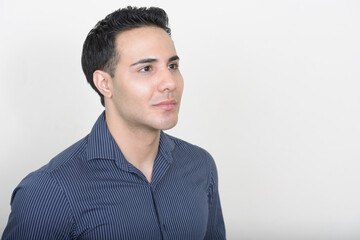 Portrait of young handsome businessman against white background