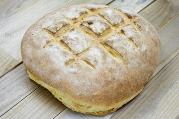 Round rustic bread on a wooden table.