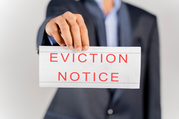 Obraz premium House Landlord or lawyer in suit showing eviction notice on isolated background.