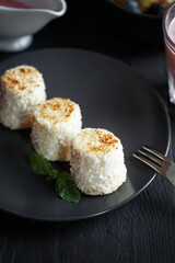 Various culinary dishes on a dark wooden table. Exquisite restaurant serve on dark dishes