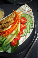 Various culinary dishes on a dark wooden table. Exquisite restaurant serve on dark dishes