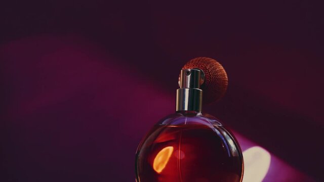 Vintage perfume bottle and shining light flares on dark background, glamorous fragrance scent as luxury perfumery product for cosmetic and beauty brand, stock footage