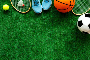 Frame of sport balls - football, basketball on grass top view copy space