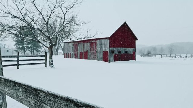 Old barn in snowy winter blizzard.