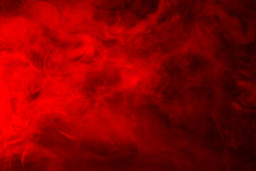 Fototapeta na wymiar Red smoke on a black background, abstract background