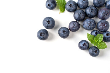 Blueberry fruit top view isolated on a white background, flat lay overhead layout with mint leaf, healthy design concept.